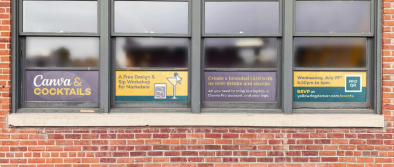 Canva and Cocktails signs in the window of YellowDog Denver.