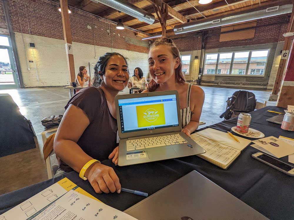 Canva and Cocktails attendees show off their designs.