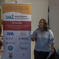 WDRC Initiatives Director Renee Martinez-Stone addresses the crowd at the West Denver Marketplaces Gift Card launch party.