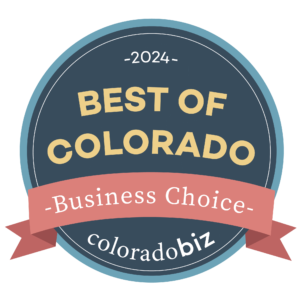 A dark blue circle with a peach-colored ribbon and the words "2024 Best of Colorado, coloradoBiz."